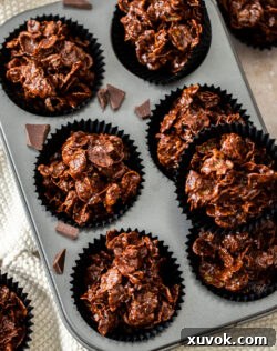 Top down view of chocolate cornflake cakes in a muffin tray.