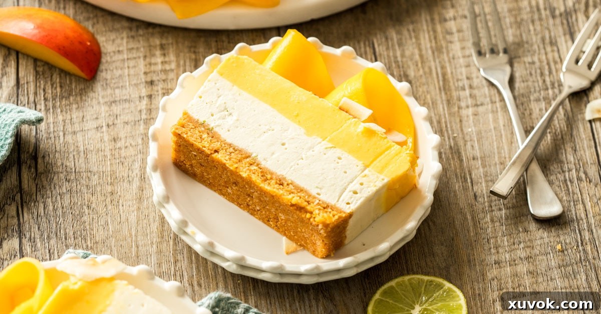 Slices of mango coconut cheesecake on white plates, with forks around and slices of lime.