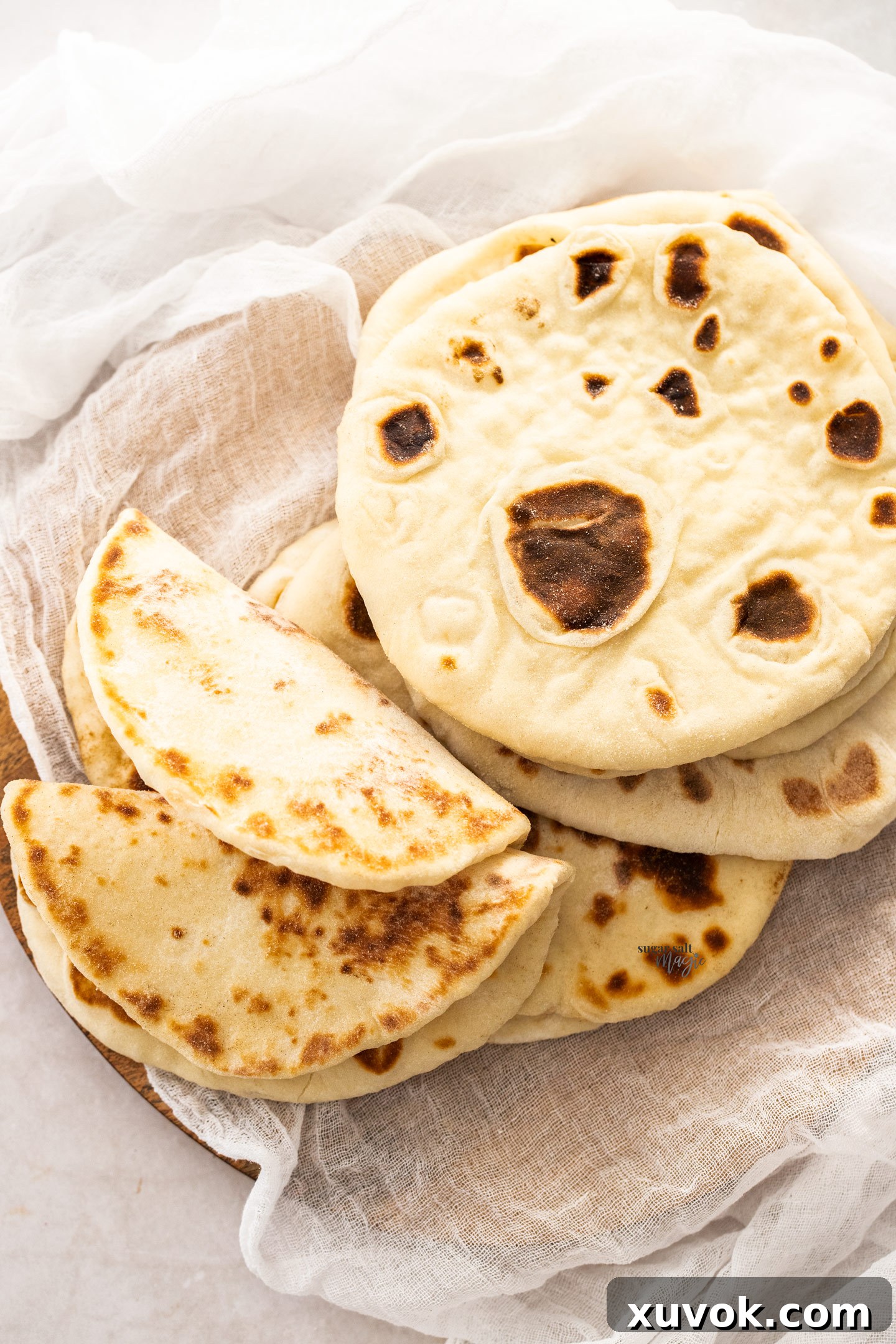 Top down view of flatbreads, some folded to show pliability.