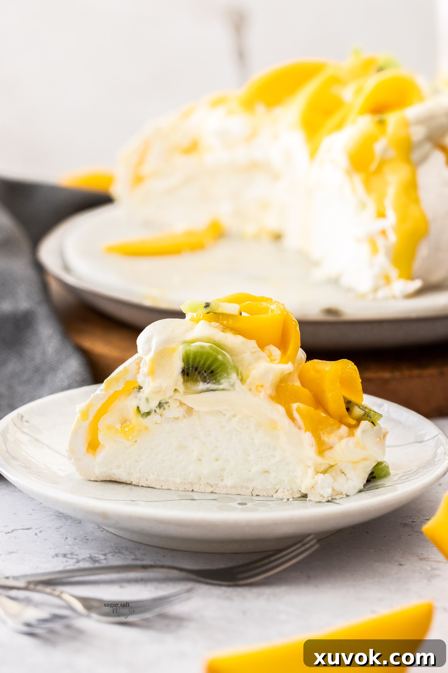 A slice of mango pavlova on a small plate.
