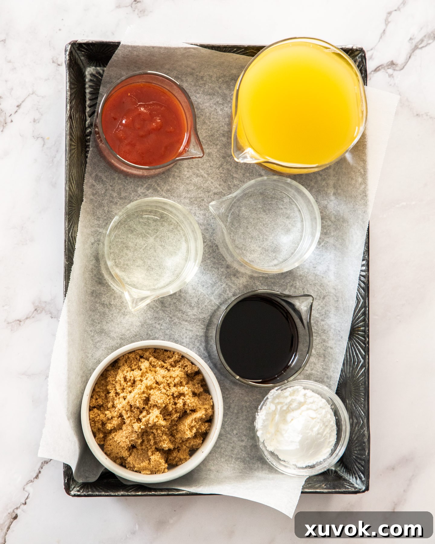 Ingredients for sweet and sour sauce laid out on a metal tray.