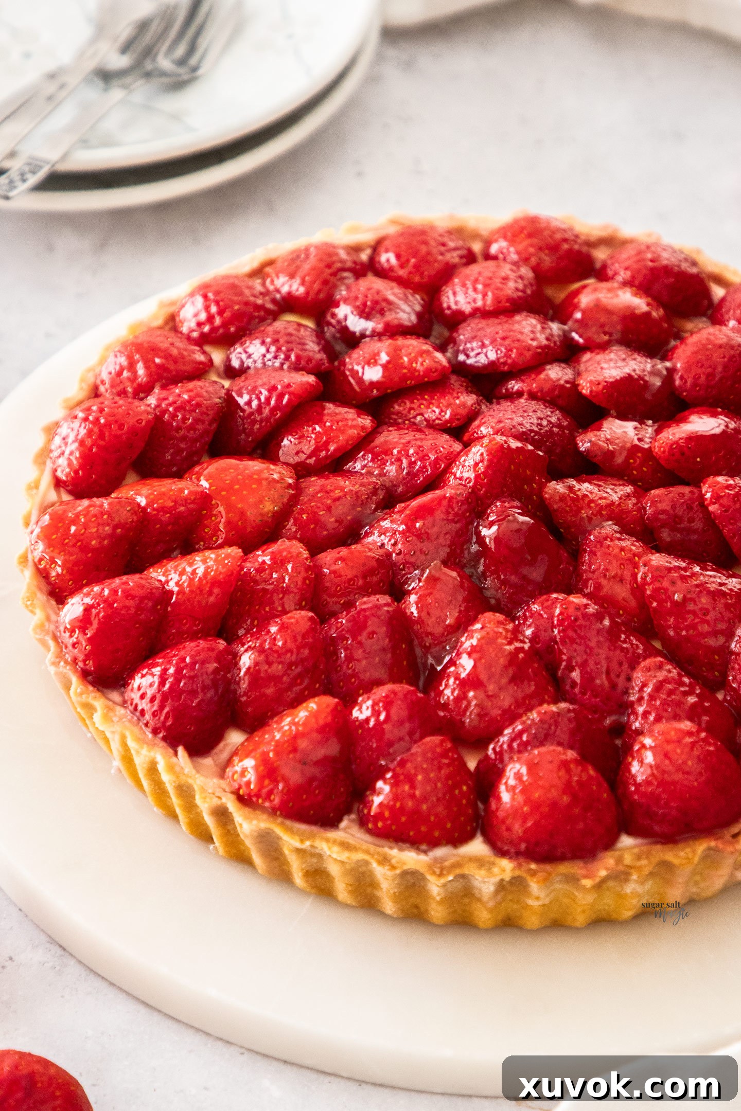 A tart topped with glazed strawberries.