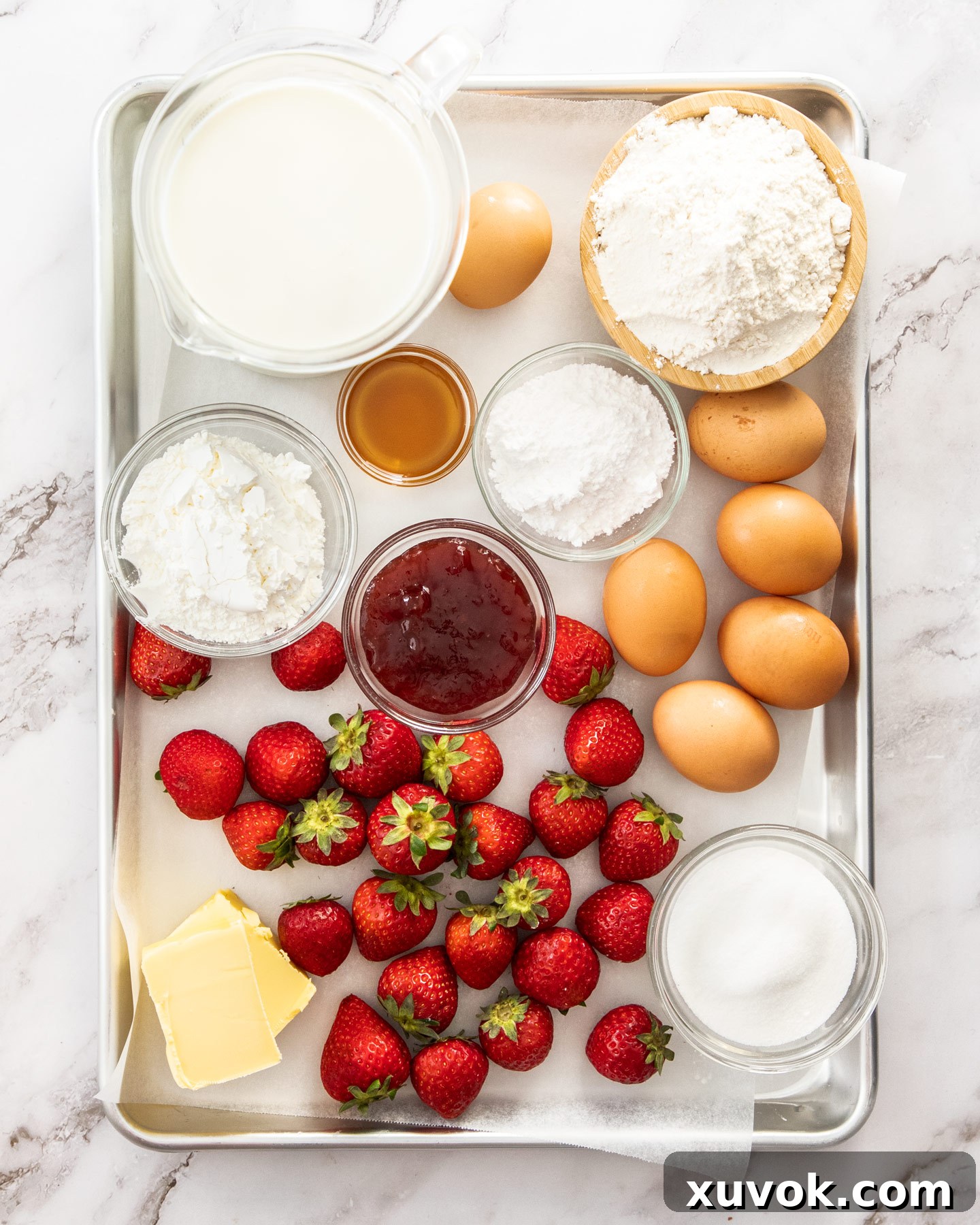 Ingredients for strawberry custard tart on a baking tray.