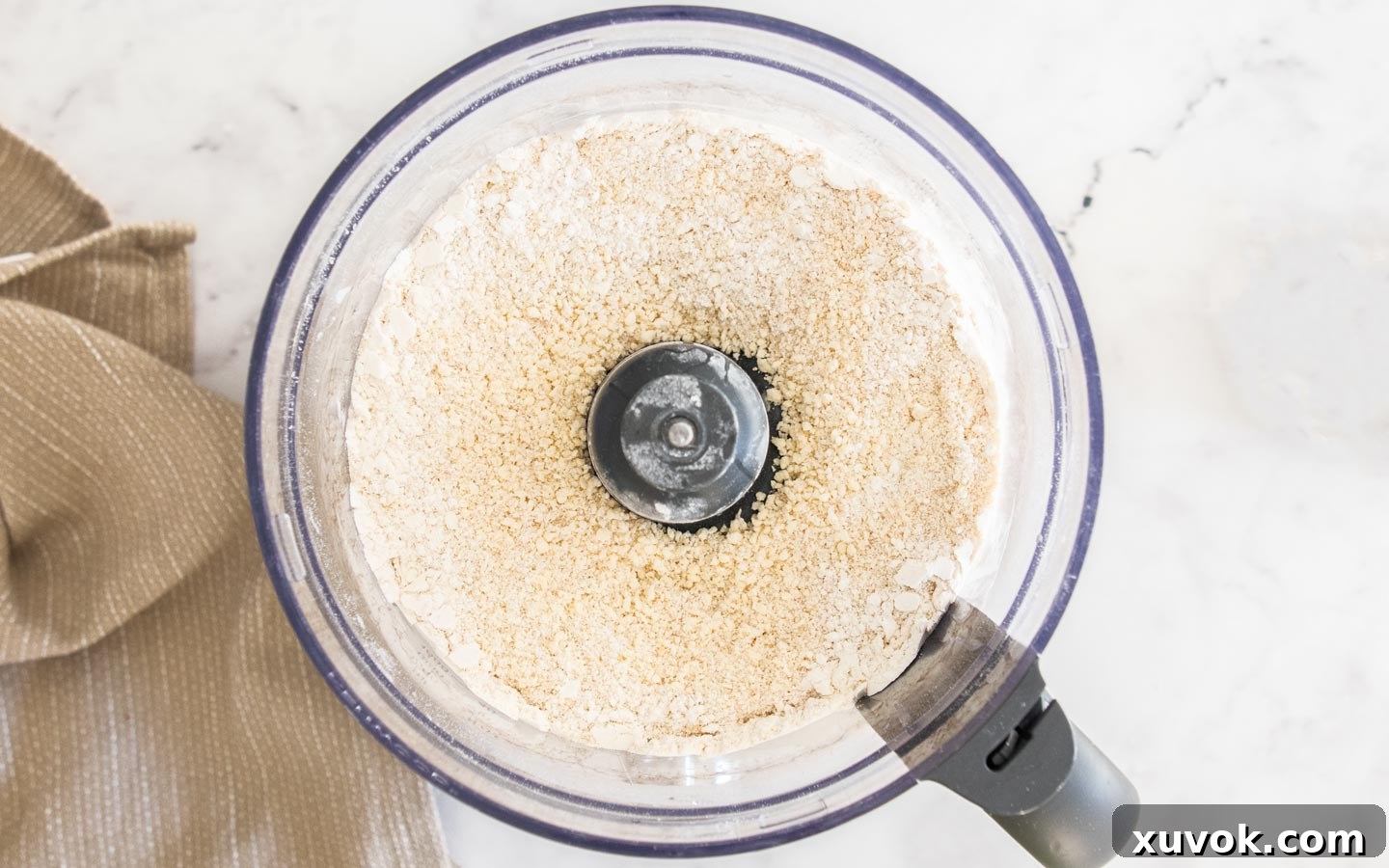The butter, flour, sugar and egg blended together in a food processor bowl.