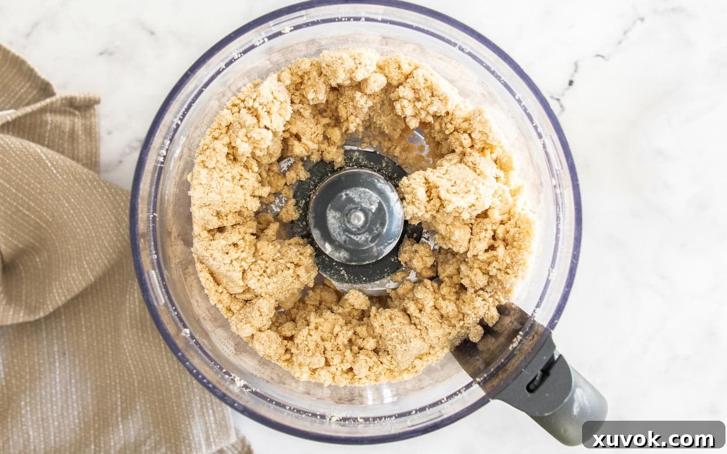 The clumping pastry dough in the food processor bowl.