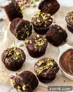 A batch of delightful chocolate muffins with pistachios and chocolate chips, ready to be enjoyed.