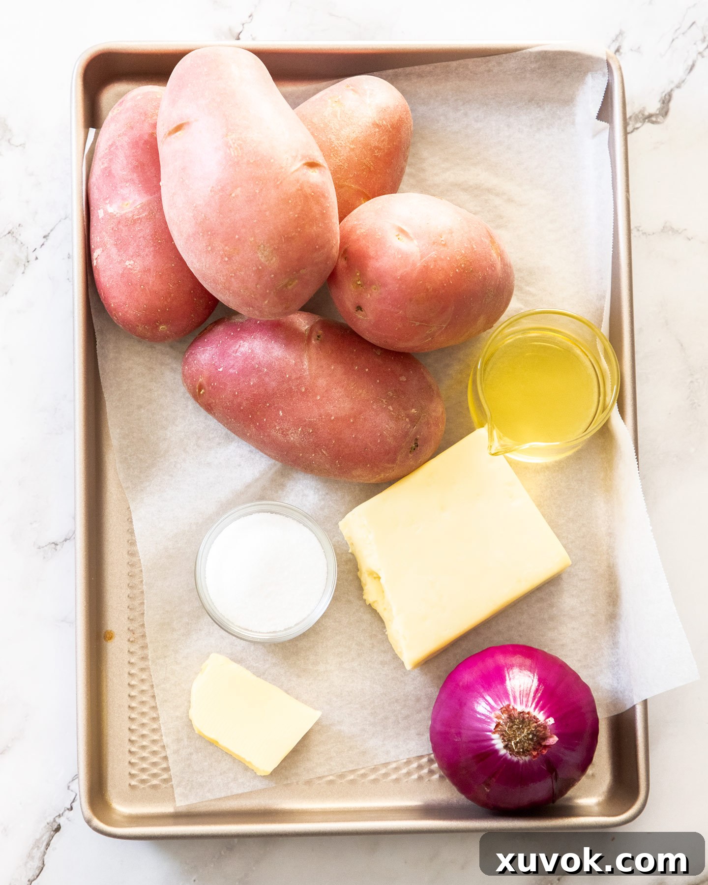 Ingredients for hash browns on a baking tray.