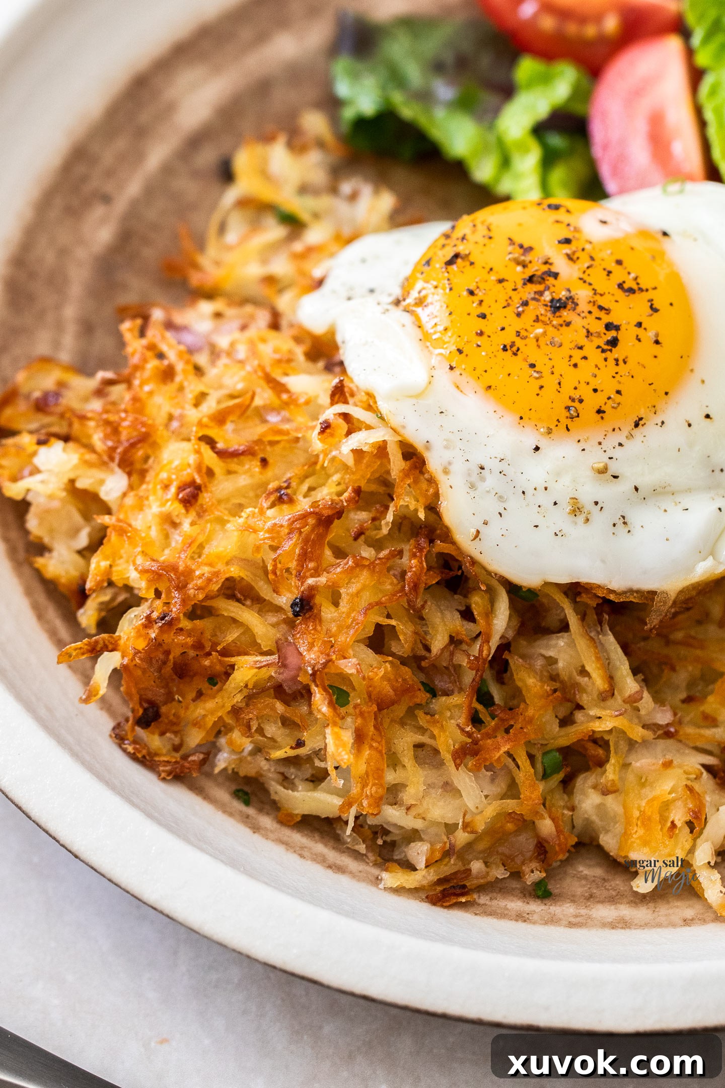 Hash browns on a plate with a fried egg on top.