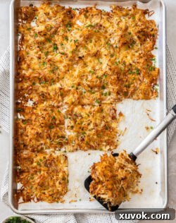 Top down view of baked hash browns on a baking tray.
