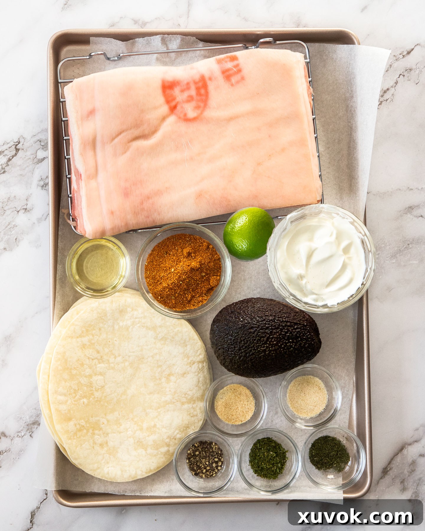 Essential ingredients for crispy pork belly tacos laid out neatly on a baking tray, ready for preparation.