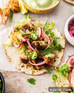 A beautifully assembled pork belly taco with fresh ingredients, ready to be enjoyed.