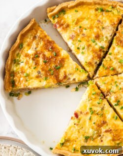 A perfectly baked quiche, artfully cut into clean slices, ready to be served and enjoyed, showcasing its golden crust and rich, savory filling.