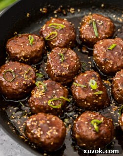 Glazed turkey rissoles in a pan.