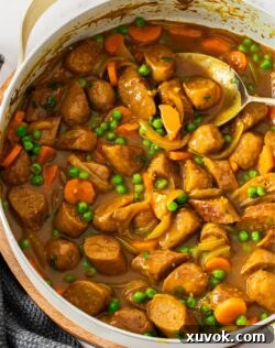 The finished curried sausages in a pan.