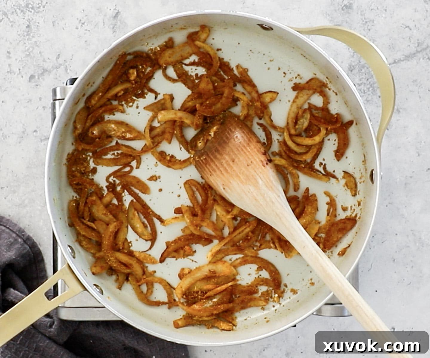 The onions and spices frying in a pan.