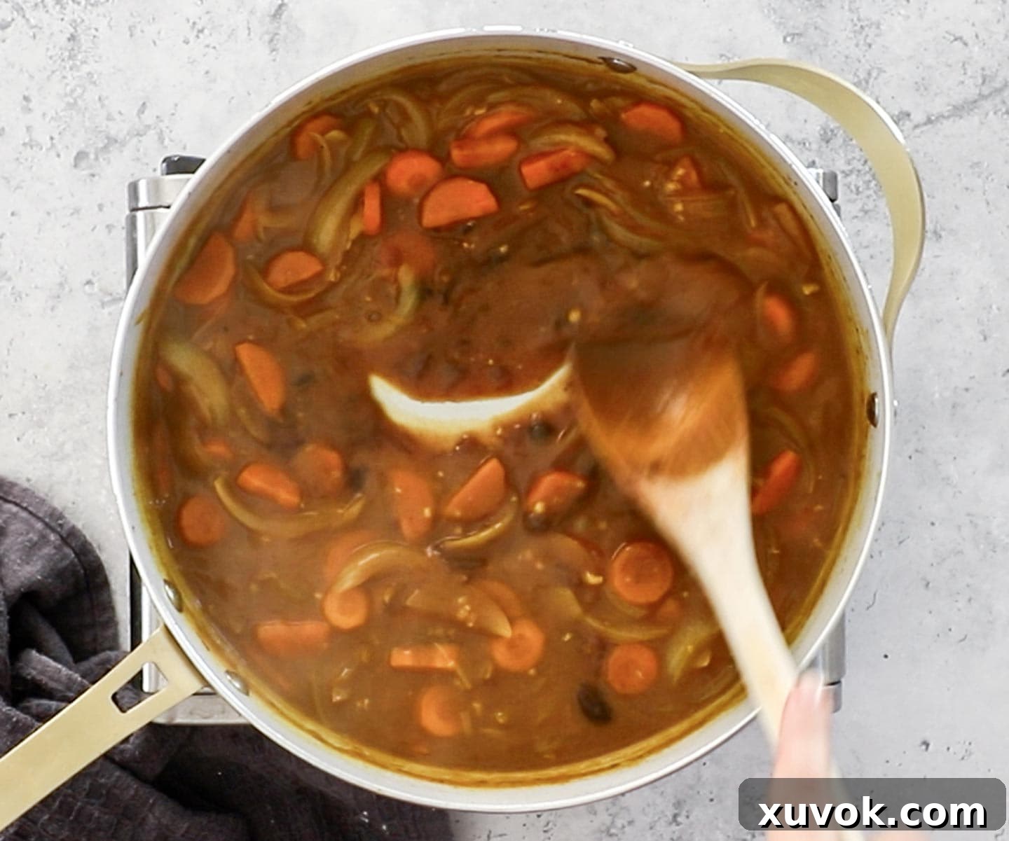 Stirring chutney into the curry gravy.