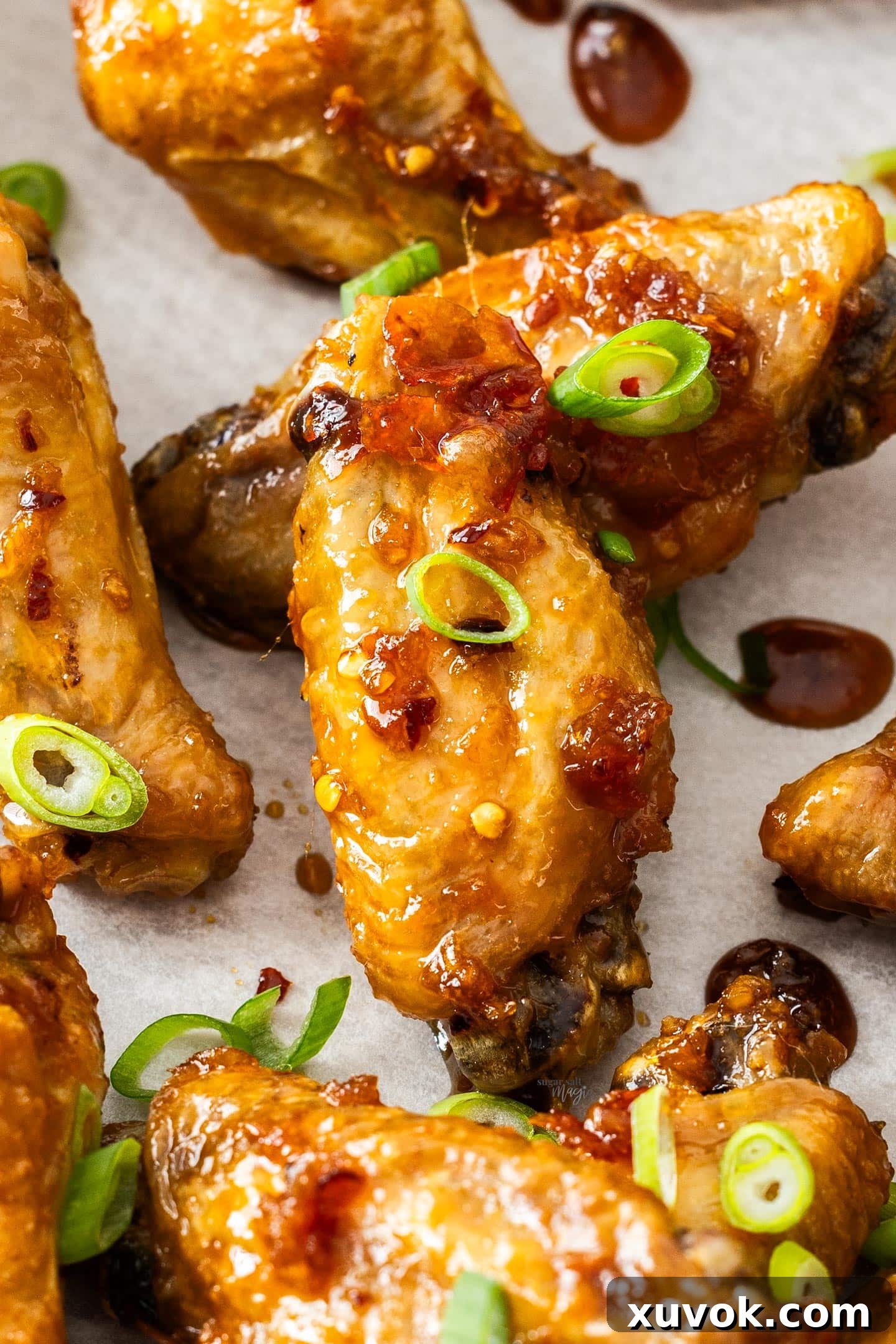 Closeup of sticky garlic honey chicken wings on a tray.