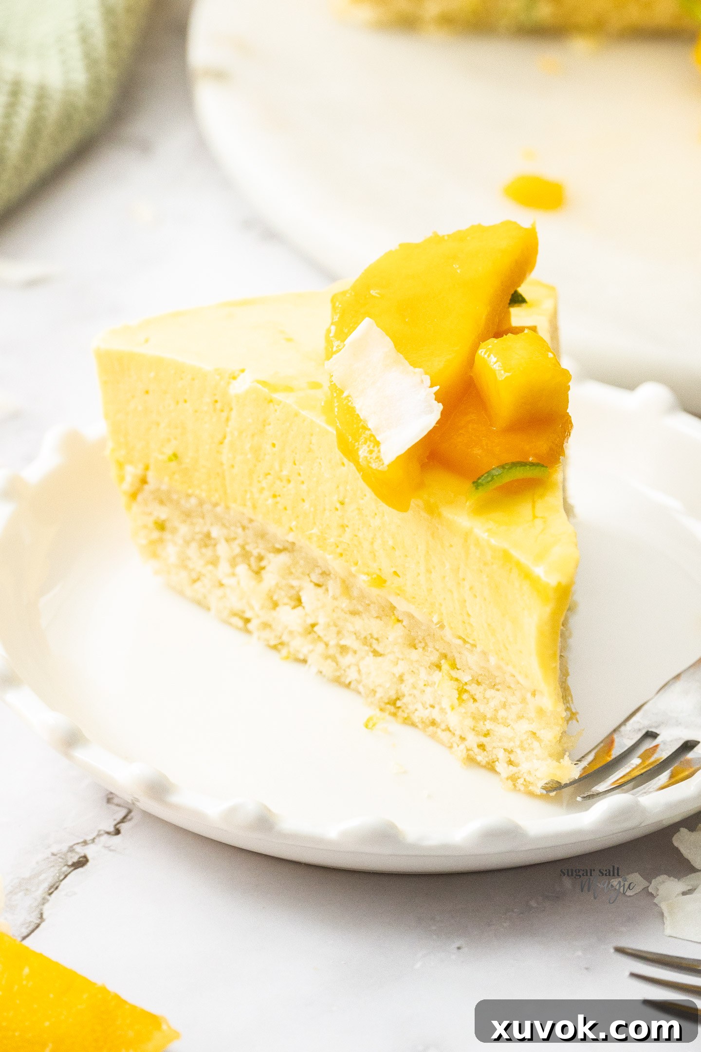 A beautiful slice of mango mousse cake presented on a dessert plate.
