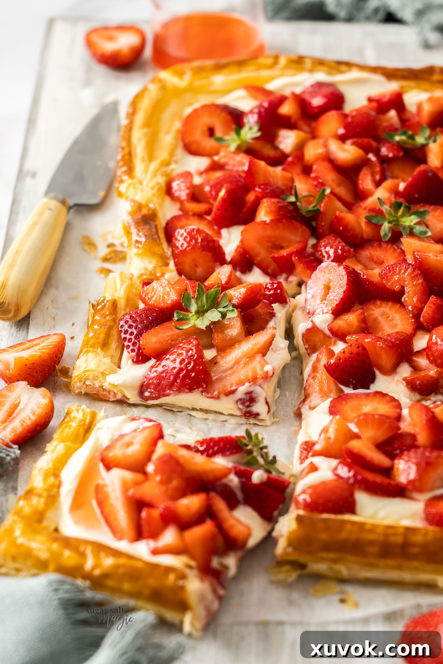 Strawberries on top of a creamy filling and puff pastry.
