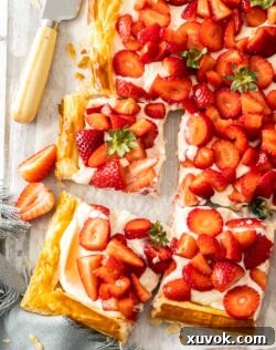 Closeup of 3 slices of strawberry puff pastry tart.