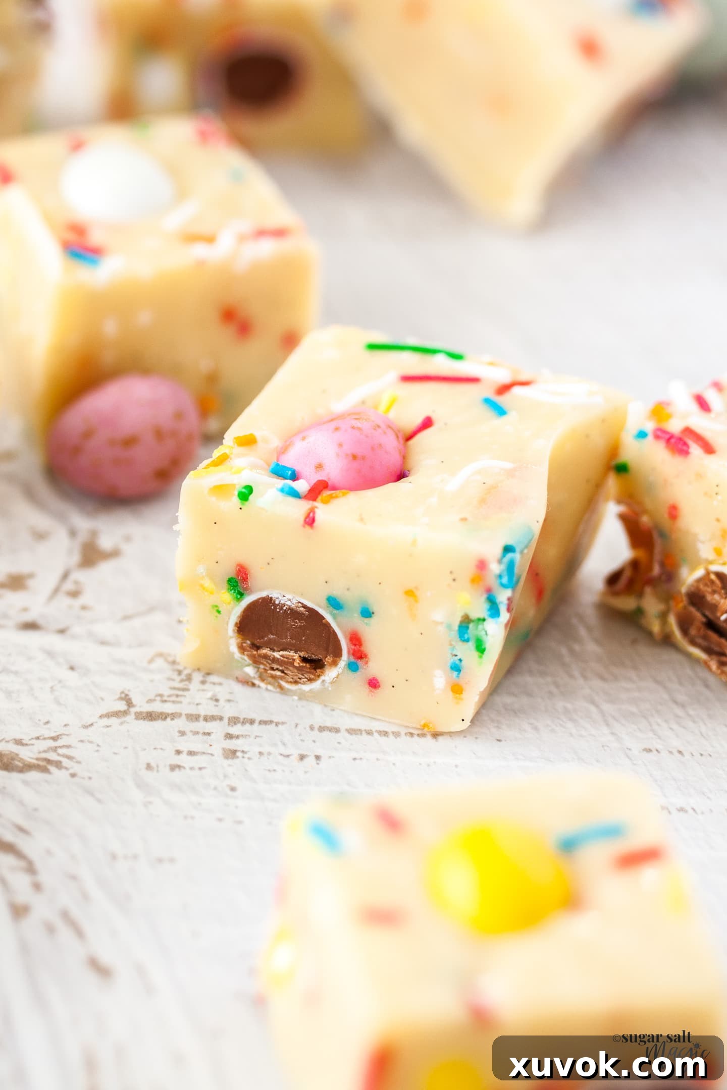 Closeup of a piece of easter egg fudge, showcasing its creamy texture and mini egg pieces.