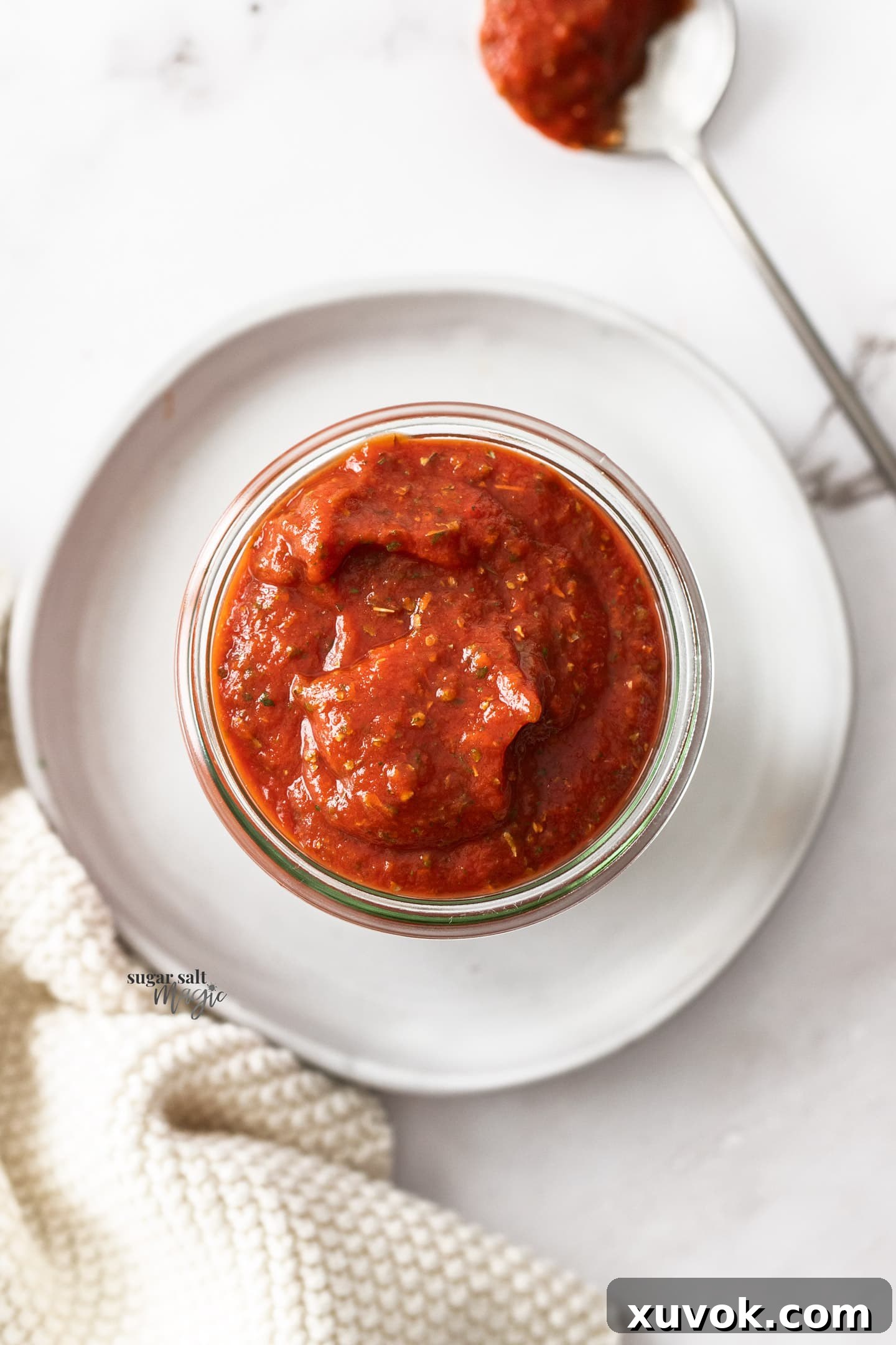 Pizza sauce in a glass jar - top down view.
