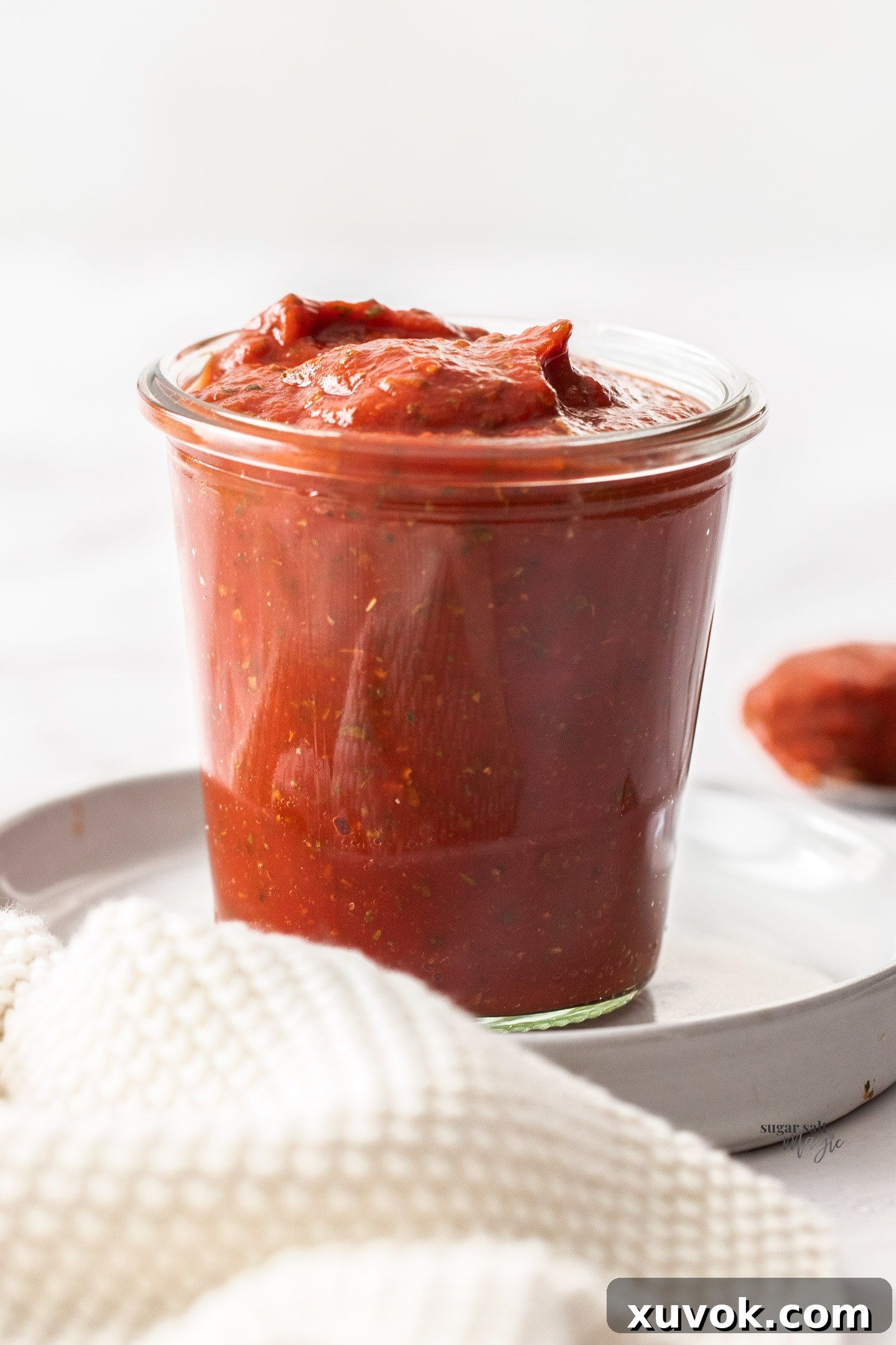 Pizza sauce in a glass jar.