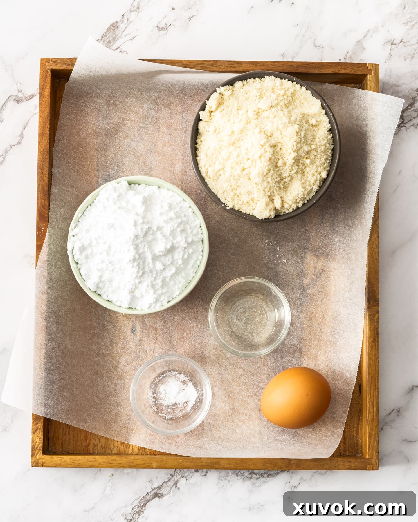 Ingredients for almond paste on a wooden tray.