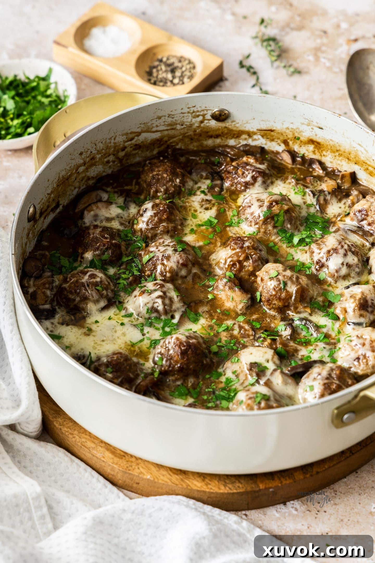 Hearty French Onion Meatballs nestled in a rich mushroom and onion gravy, topped with melted Gruyere cheese, ready to be served for a comforting dinner.