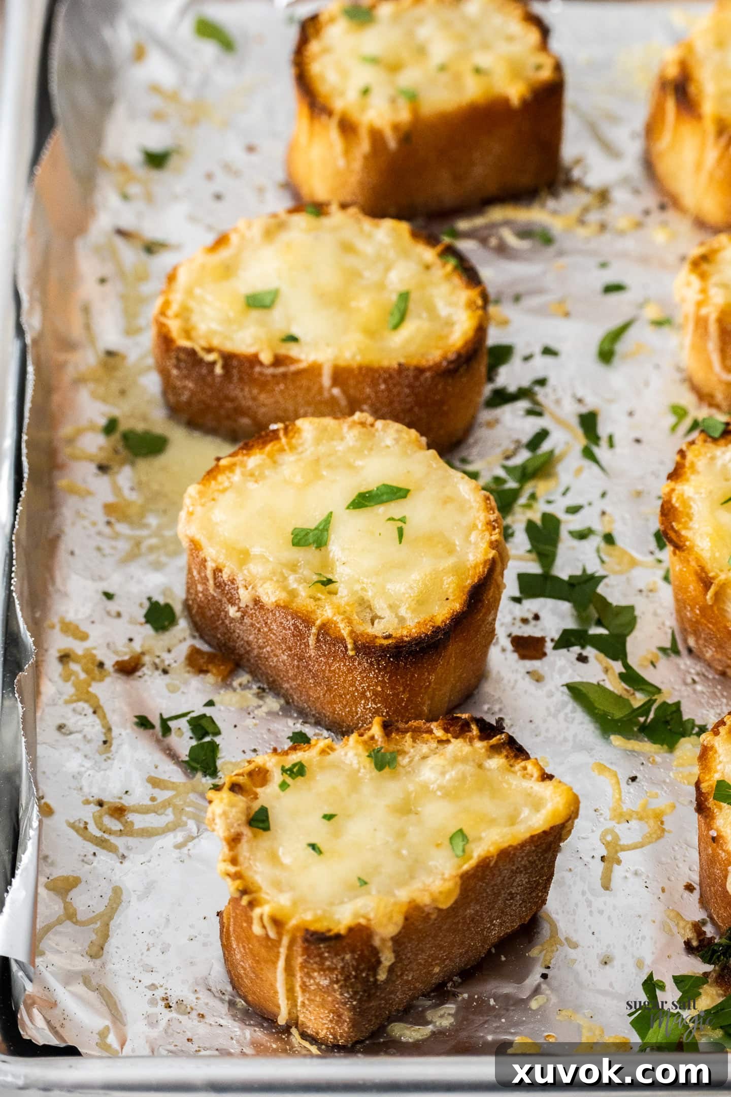 Close-up view of golden, crispy Gruyere croutons with perfectly melted cheese, freshly removed from the oven.