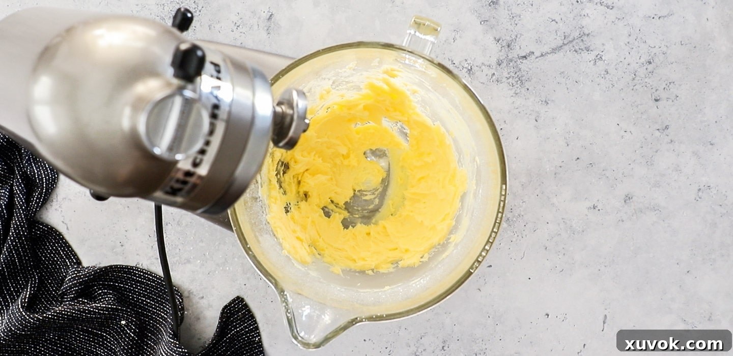 Some butter and sugar in a mixing bowl.