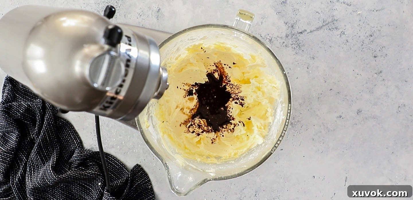 A stand mixer with whipped butter and coffee added.