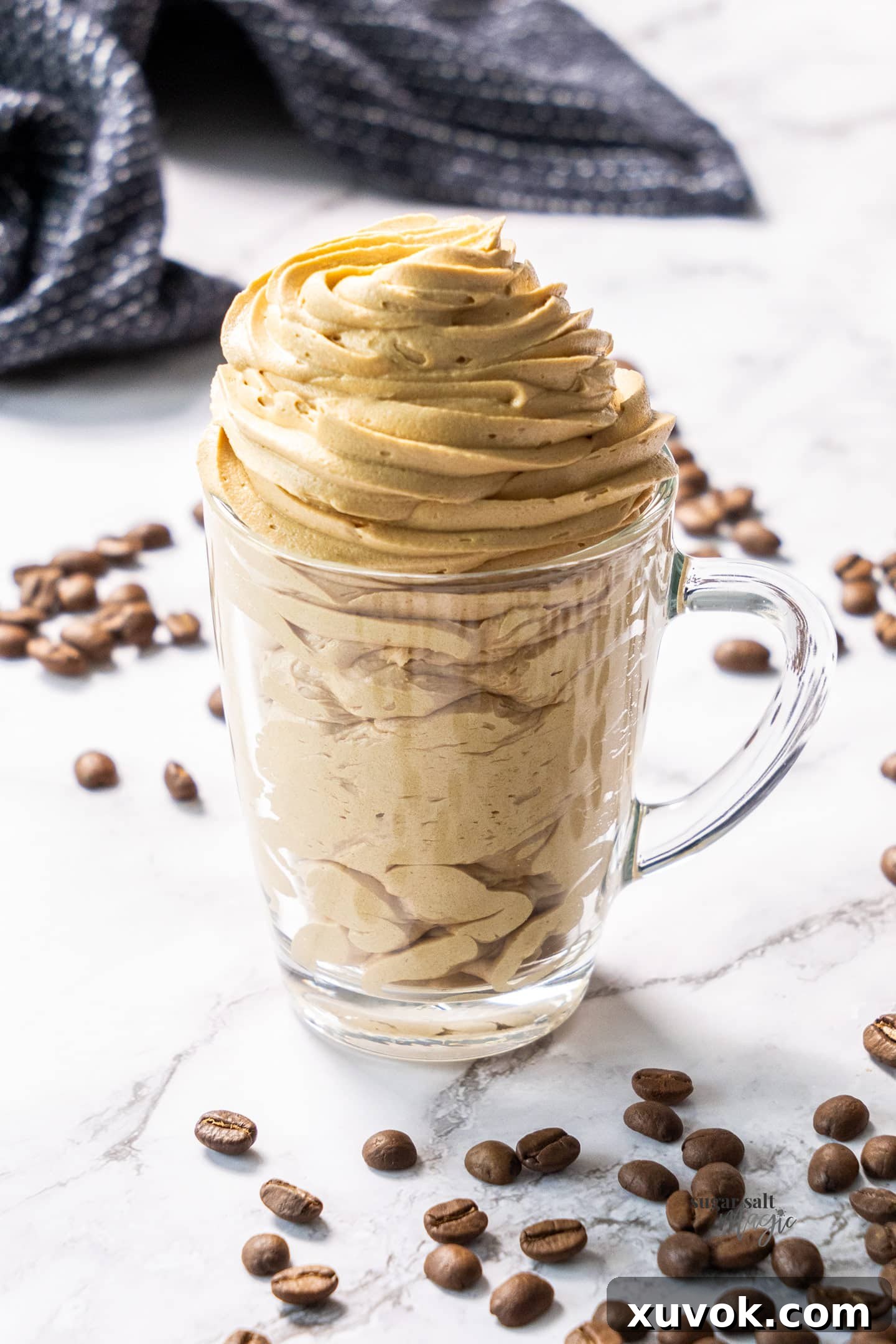 Coffee buttercream piped into a coffee glass.