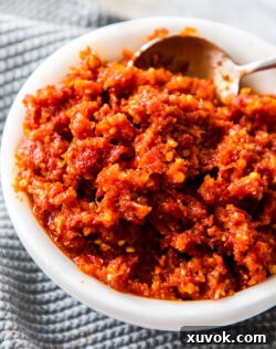 A marble bowl filled with sun dried tomato pesto.