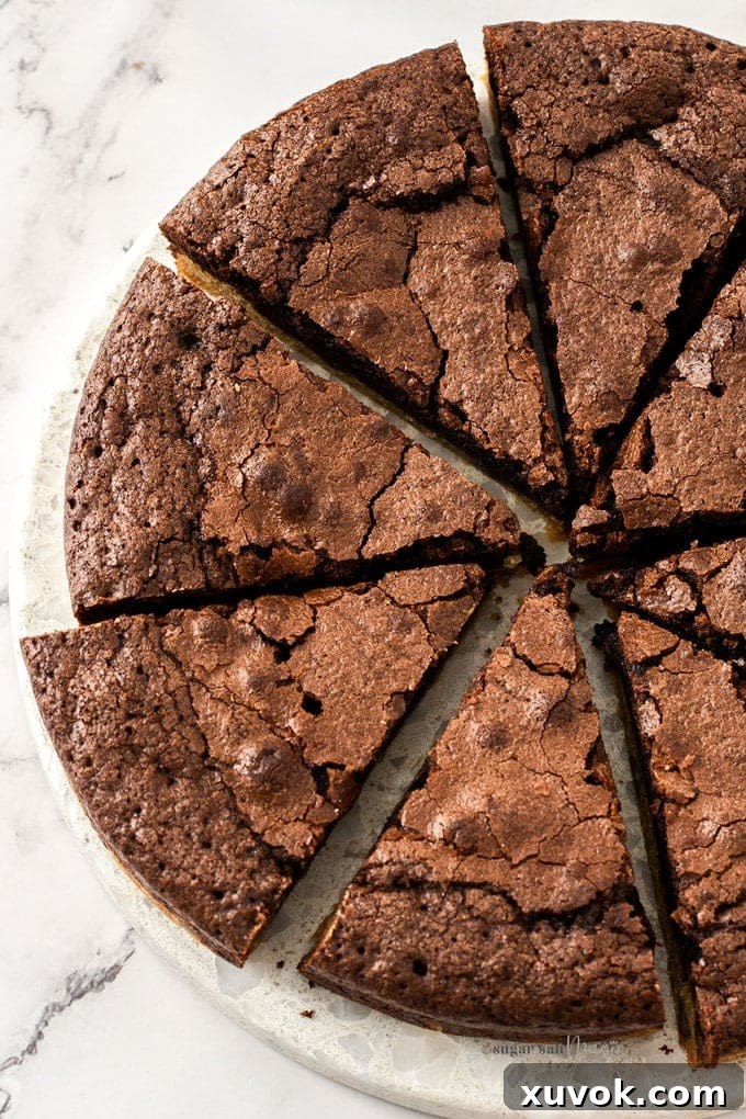 Top down view of 8 slices of brownie pie on a white marble platter.