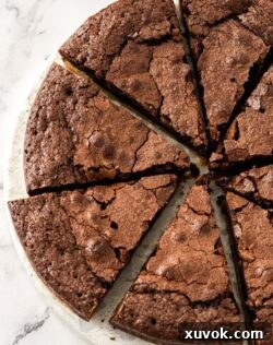 Top down view of 8 slices of brownie pie on a white marble platter