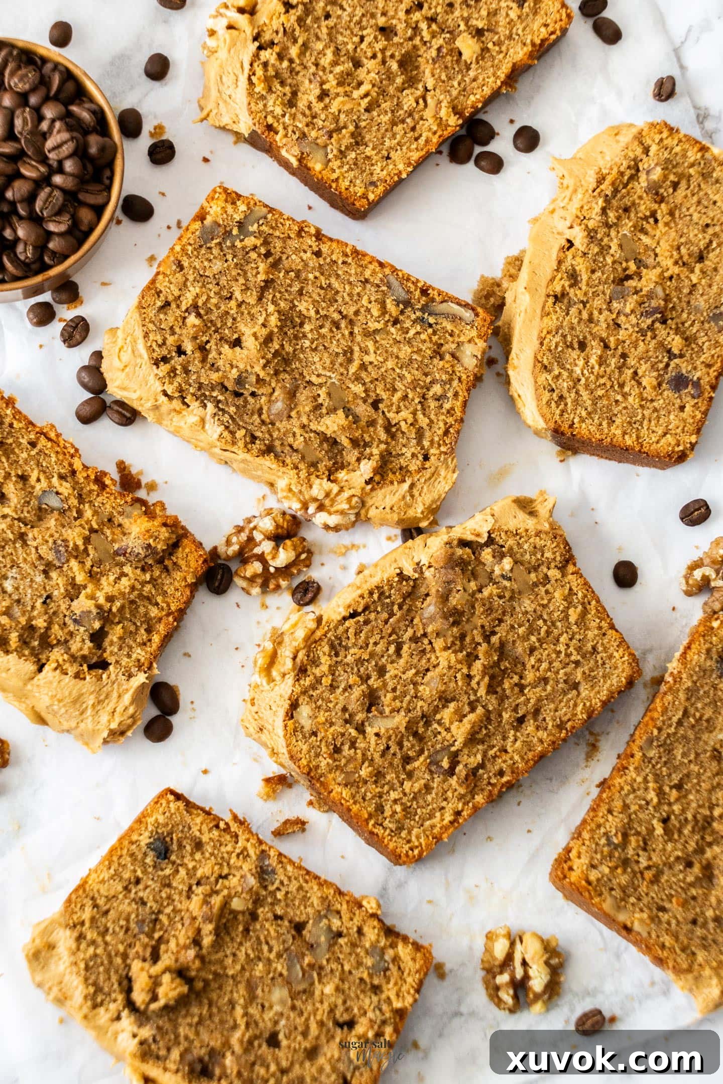 Beautifully cut slices of moist coffee loaf cake with creamy frosting, presented elegantly on a serving dish, inviting indulgence.