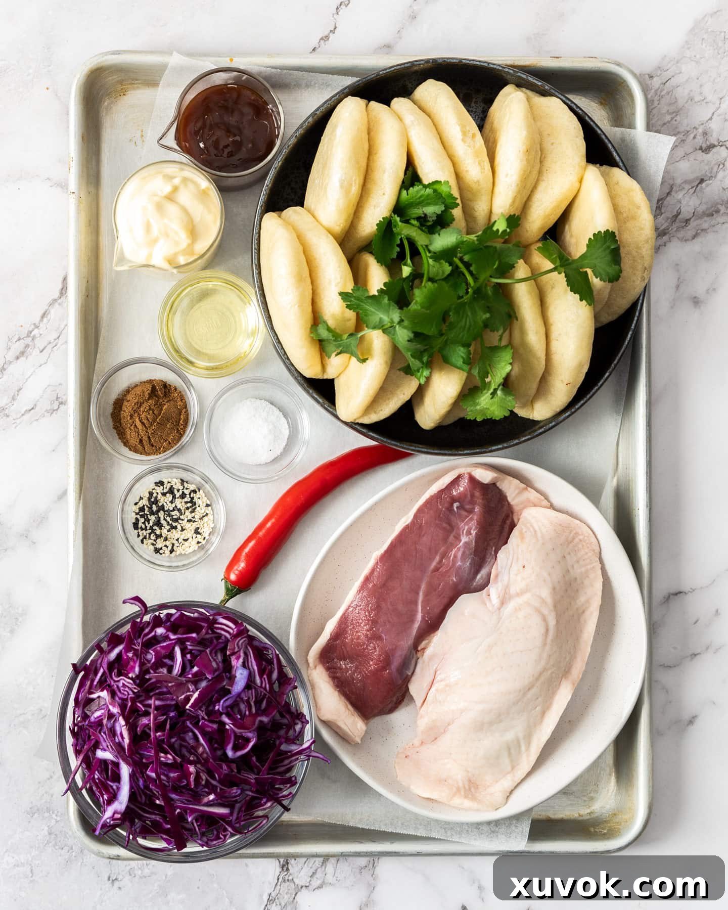 Ingredients for duck bao buns on a baking tray.