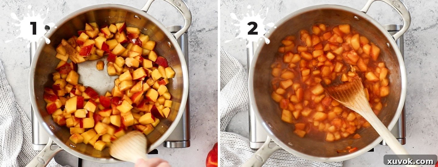 Diced peaches, sugar, and spices simmering in a stainless steel saucepan, creating a vibrant compote.