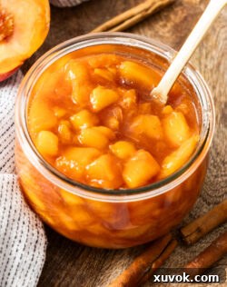 Top-down view of the luscious peach compote in a jar, showcasing its beautiful texture.