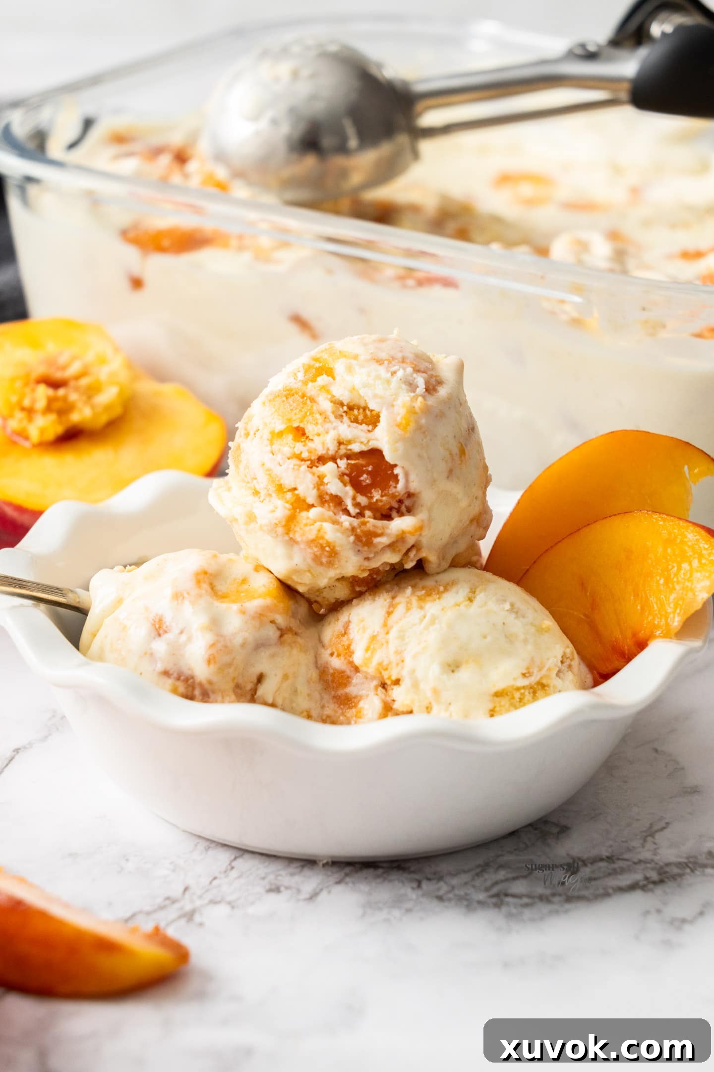 A beautiful bowl filled with scoops of peach cobbler ice cream, ready to be enjoyed.