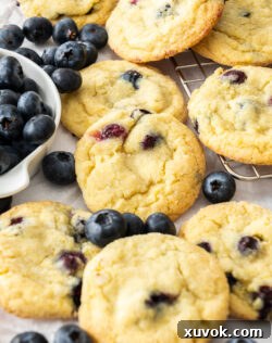 Closeup of the baked lemon blueberry cookies with blueberries around.