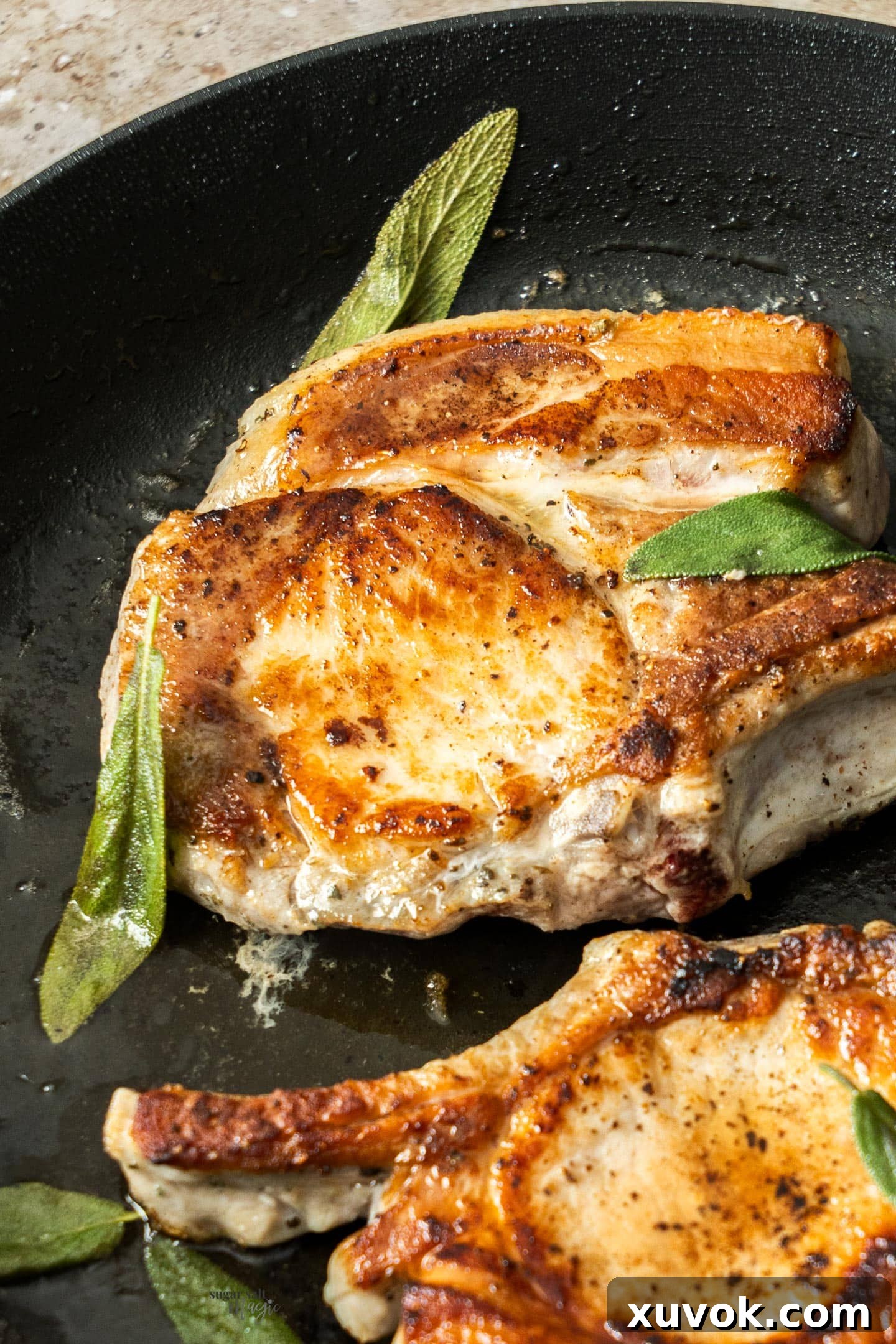 A close-up shot of a sizzling pork chop in a cast iron skillet, showcasing a perfect sear and golden-brown crust.