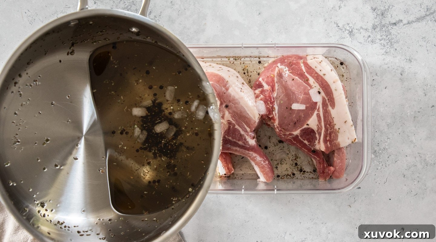 The cooled brine being poured carefully over raw pork chops submerged in a glass dish, ensuring full coverage.