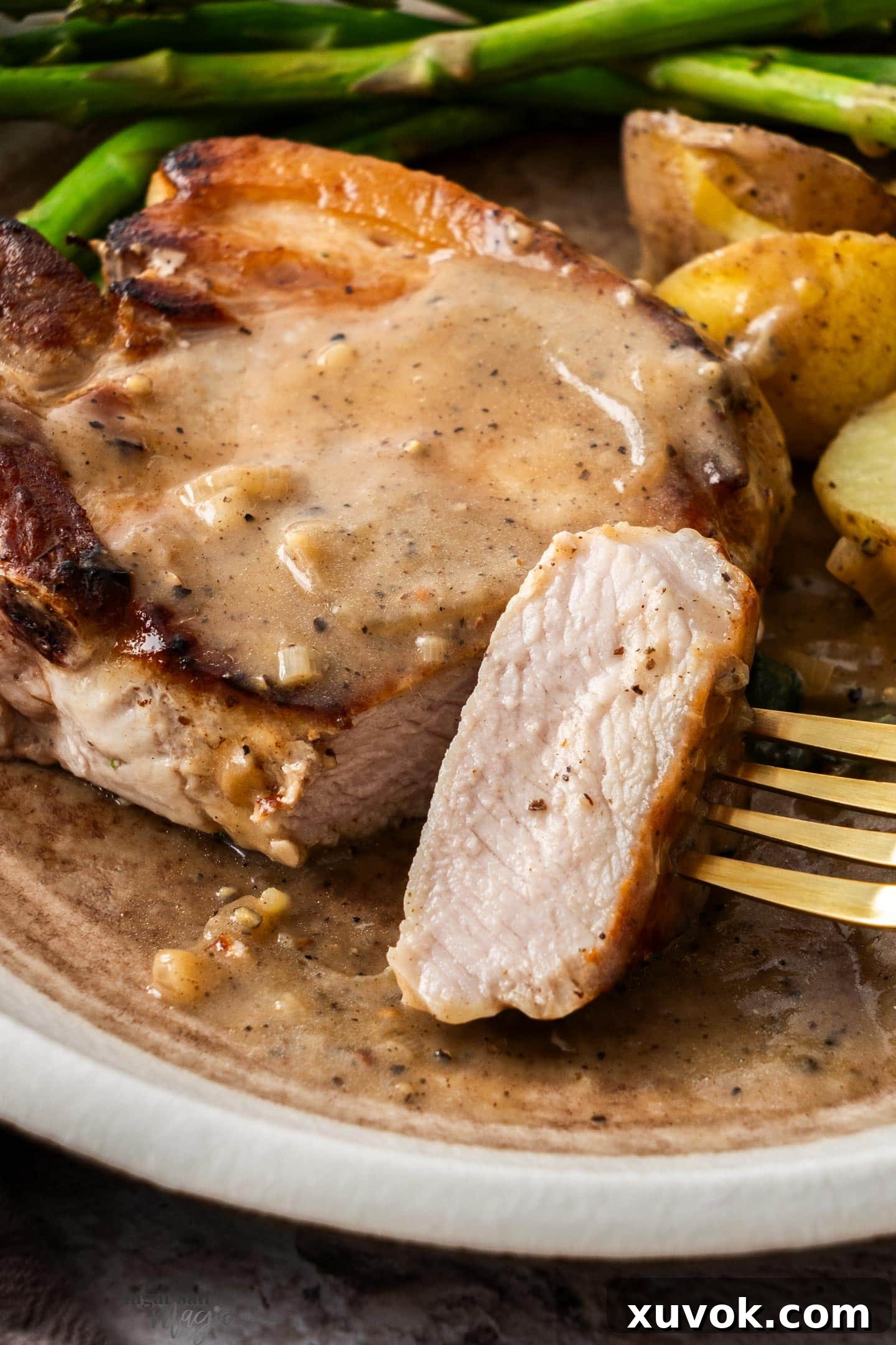Closeup of a perfectly cooked slice of pork, demonstrating its moist and tender interior.