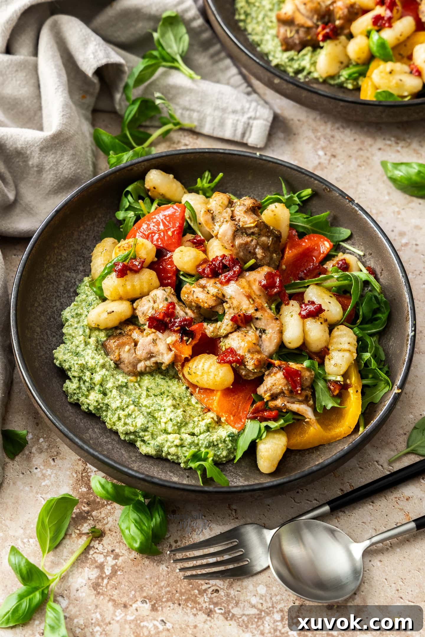 A plate with chicken, ghocchi and vegetables.