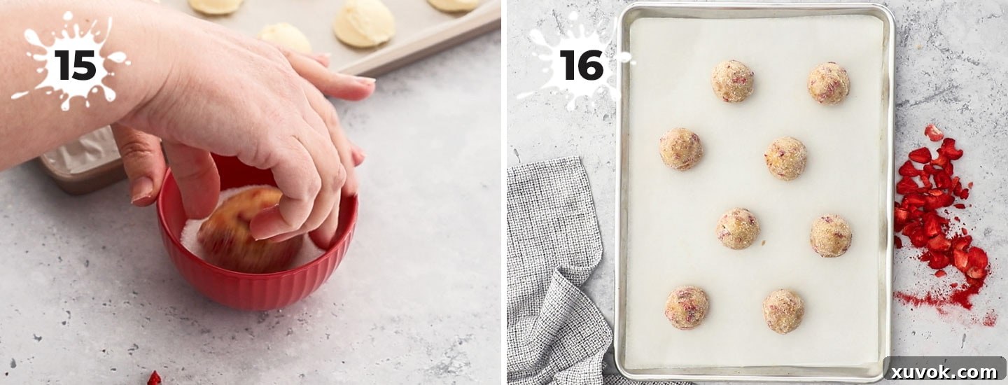 Cookie dough on a baking tray ready for baking. These strawberry cheesecake cookies are buttery, thick, soft, and creamy all in one bite with crisp edges. The gorgeous cookies are spiked with real strawberry pieces and a rich cheesecake centre!