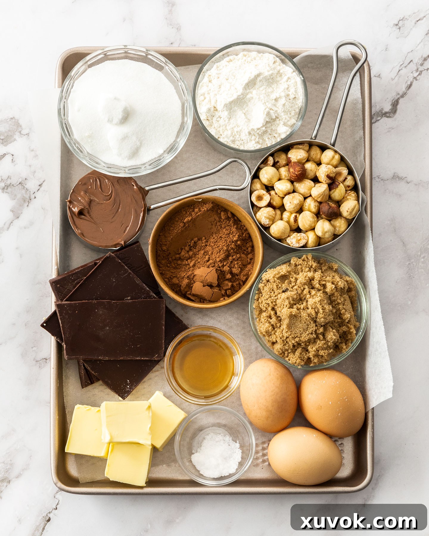 Ingredients for hazelnut brownies on a baking tray.