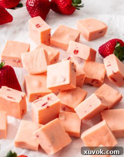 A pile of squares of strawberry fudge, perfect for a sweet treat.