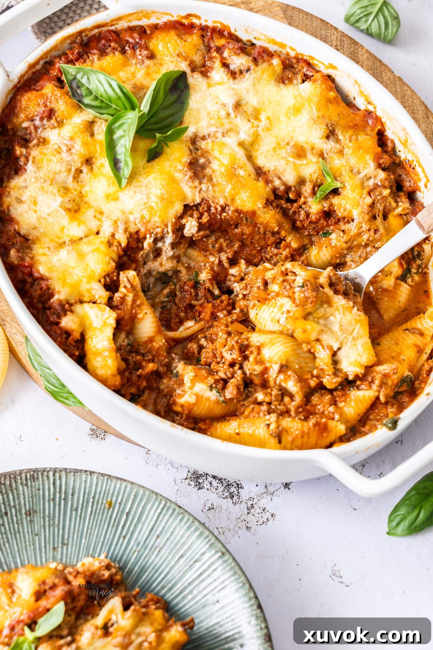 A baking dish filled with baked lasagna stuffed shells.